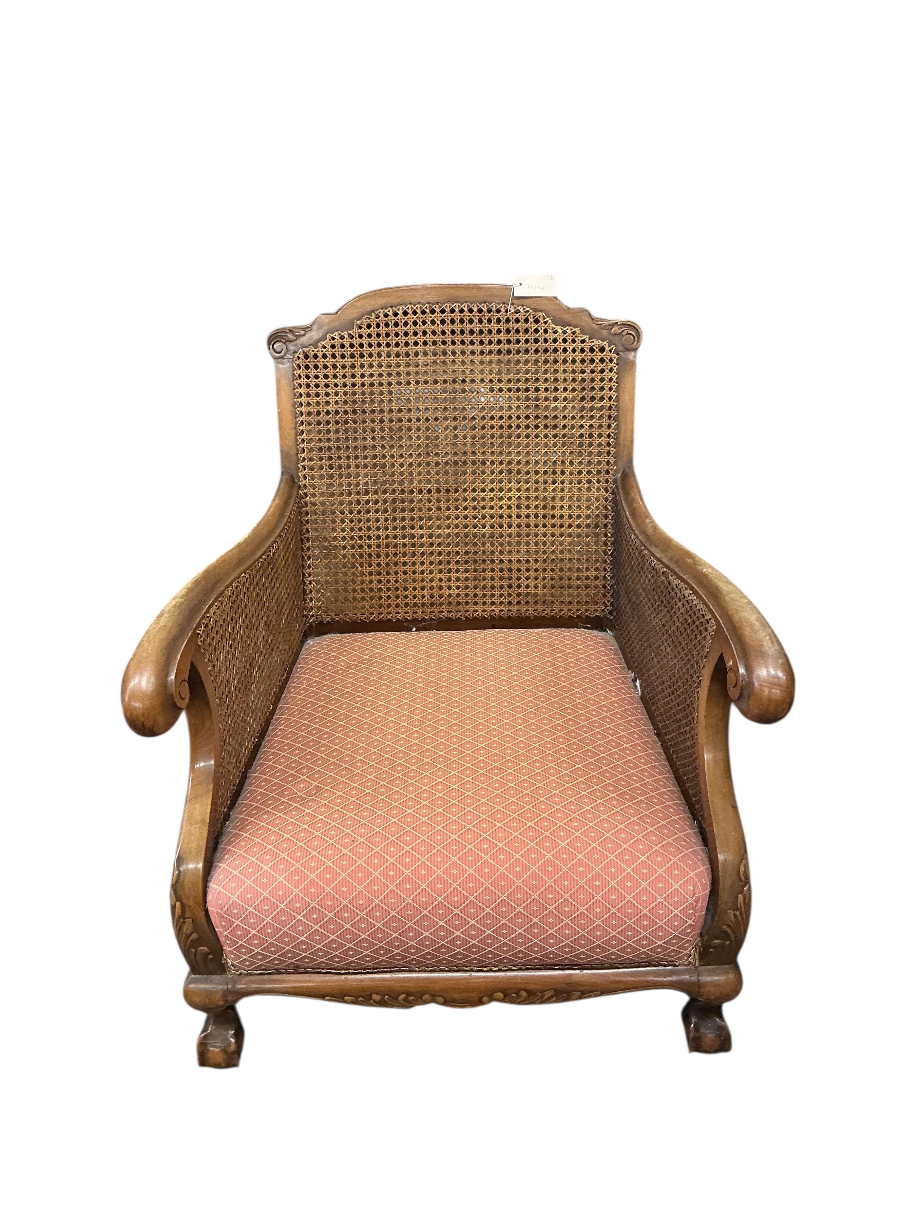An early 20th century mahogany three piece bergere suite